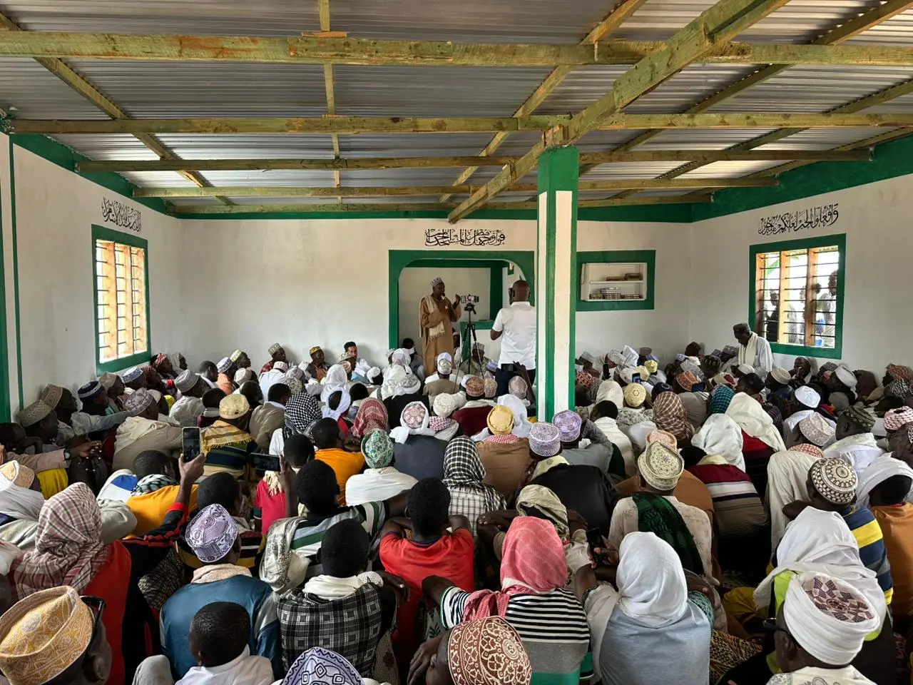 Community worshippers praying inside newly built mosque
